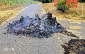 Polizeipräsidium Westpfalz: POL-PPWP: Heuballen angezündet und Pkw beschädigt