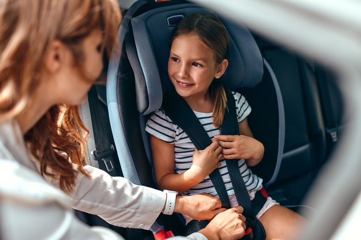 Road Safety - Mother put her daughter in a car seat - smaller.jpg