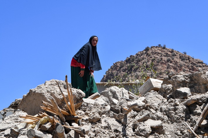 Frau steht im vom Erdbeben zerstörten Dorf Imoulas (Provinz Taroudant) auf den Trümmern eines Ha.jpg