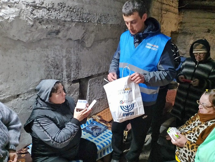 Ein Helfer verteilt Hilfsgüter in einem Schutzkeller in der Ukraine. ©IsraAID Germany.JPG