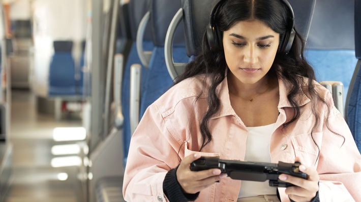 Ericsson - A woman on a train playing a game on her phone.jpg